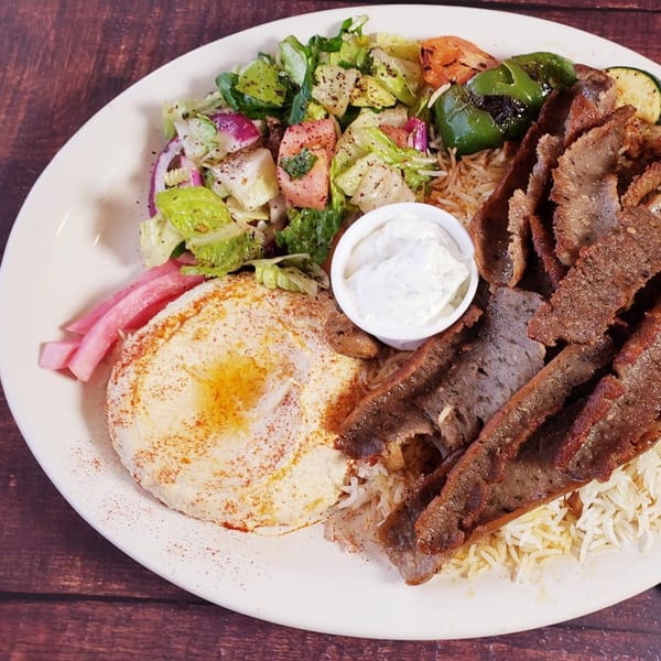 Sam's Pita and Kabab's gyro plate with meat, rice, hummus, salad, and pickled turnips.